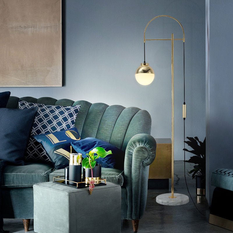 Lámpara de pie arco dorado Solvela – en un salón azul