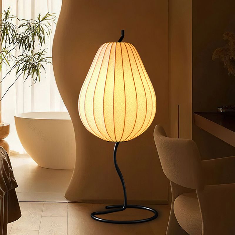 Lámpara de pie en forma de pera con pantalla de tela Fidela junto a un sofá en el salón – imagen 7