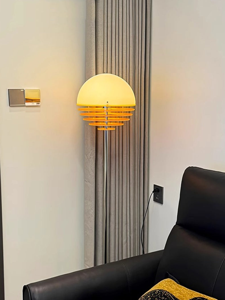 Lámpara de pie Bauhaus Tuneva – encendida junto a un sofá