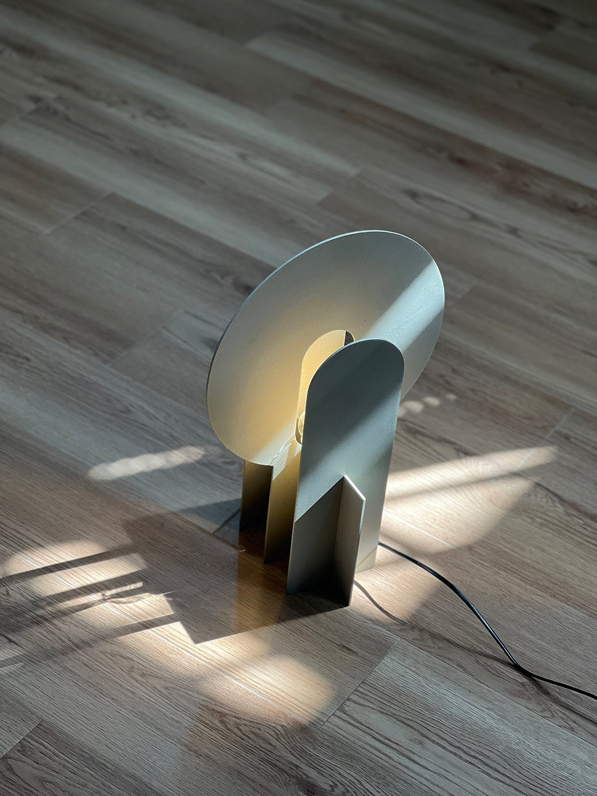 Lámpara de mesa de acero con arco Mardela sobre un aparador moderno – imagen 21