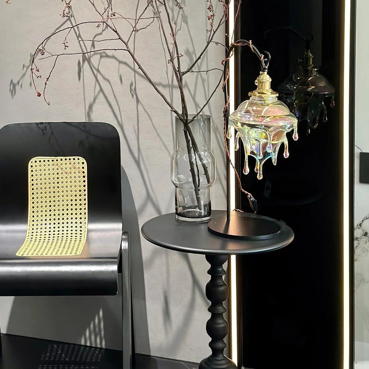 Lámpara de mesa de cristal Rociela – sobre un velador junto a una silla