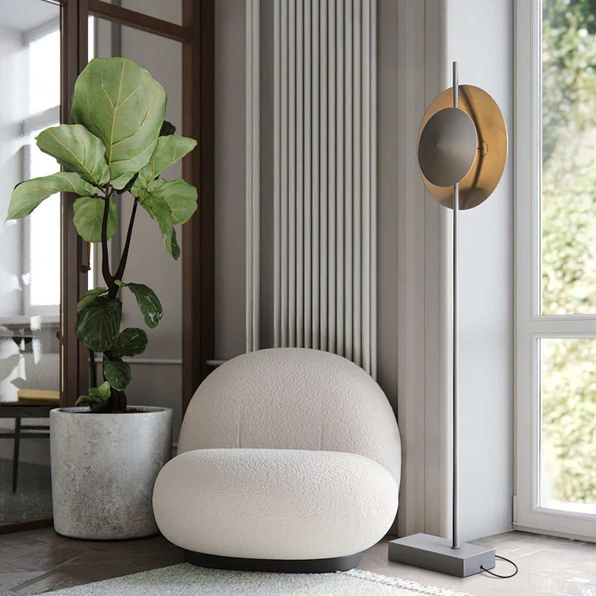 Lámpara de pie con dos pantallas circulares grises Eclipra junto a un sillón en un dormitorio – imagen 11