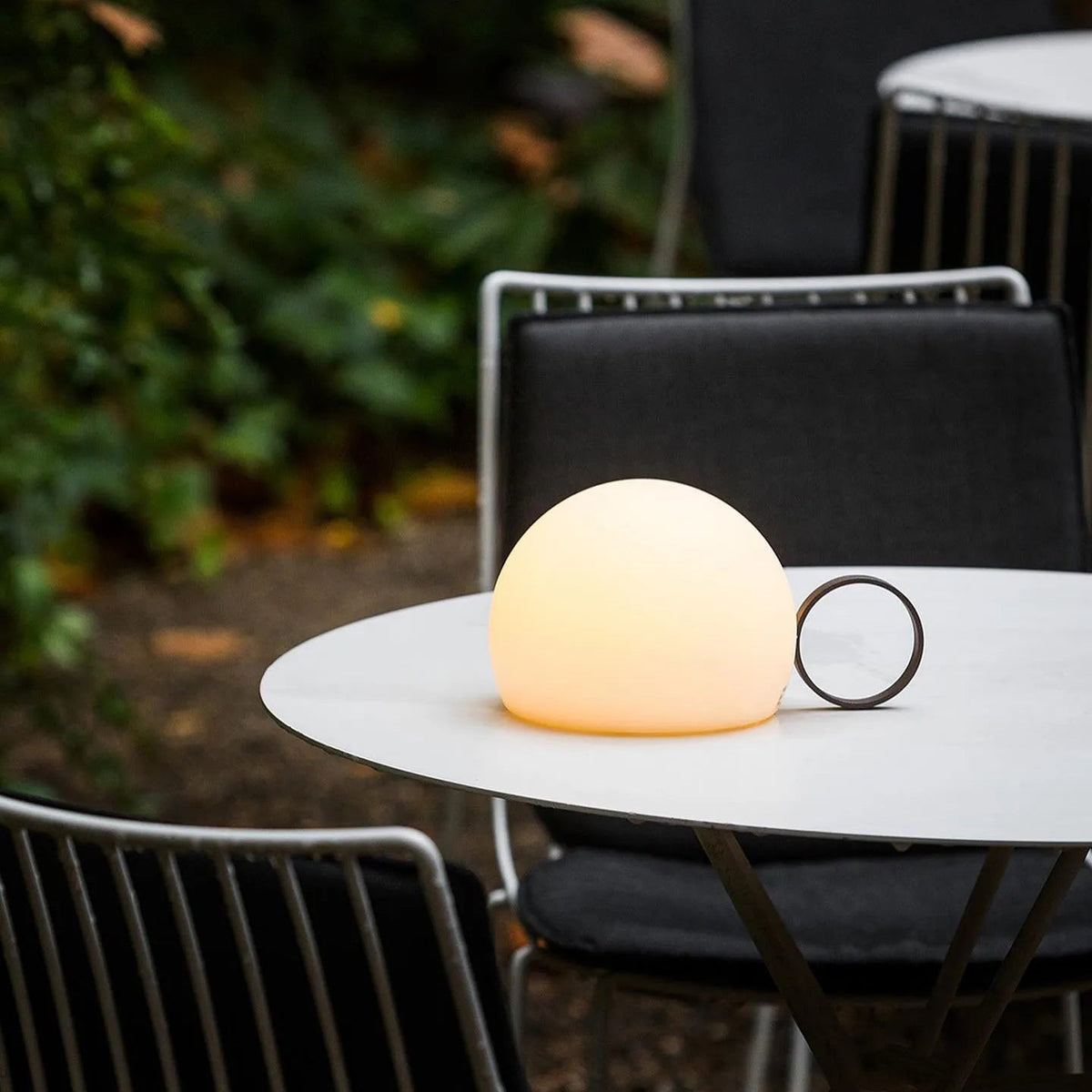 Lámpara de mesa recargable Aroleta en una terraza al anochecer – imagen 21