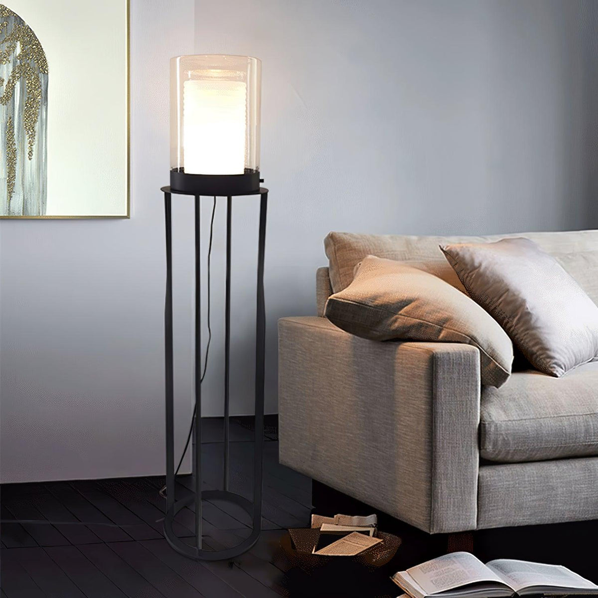 Lámpara de pie LED de doble cilindro de vidrio y estructura negra Navira – junto a un sillón beige