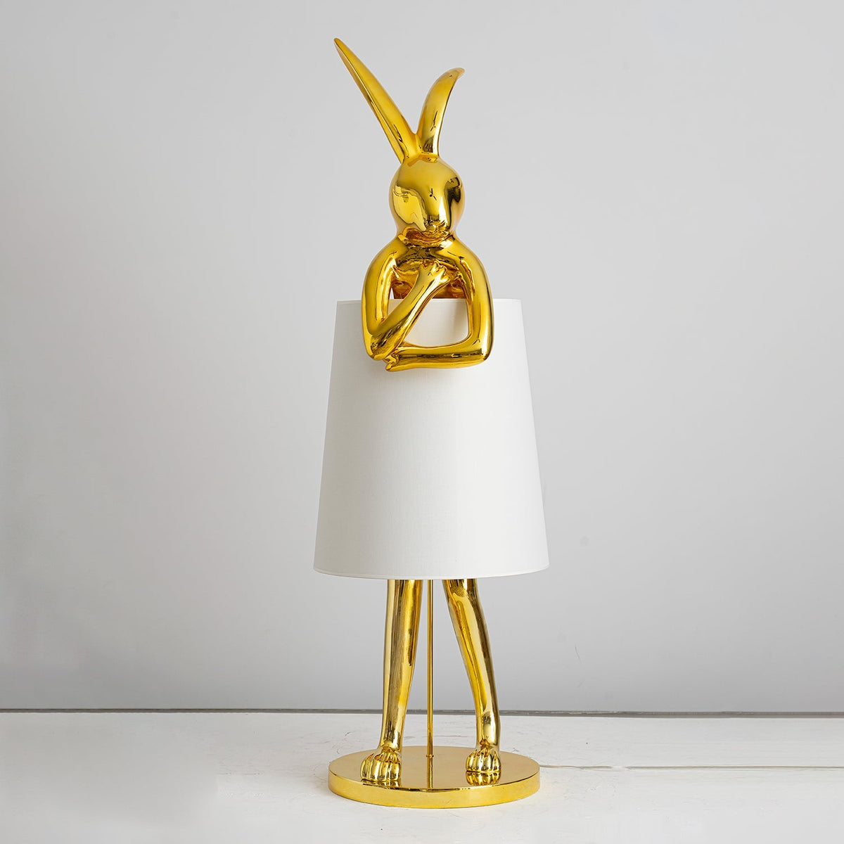 Lámpara de pie escultura de liebre Rabela – en dorado brillante con pantalla blanca