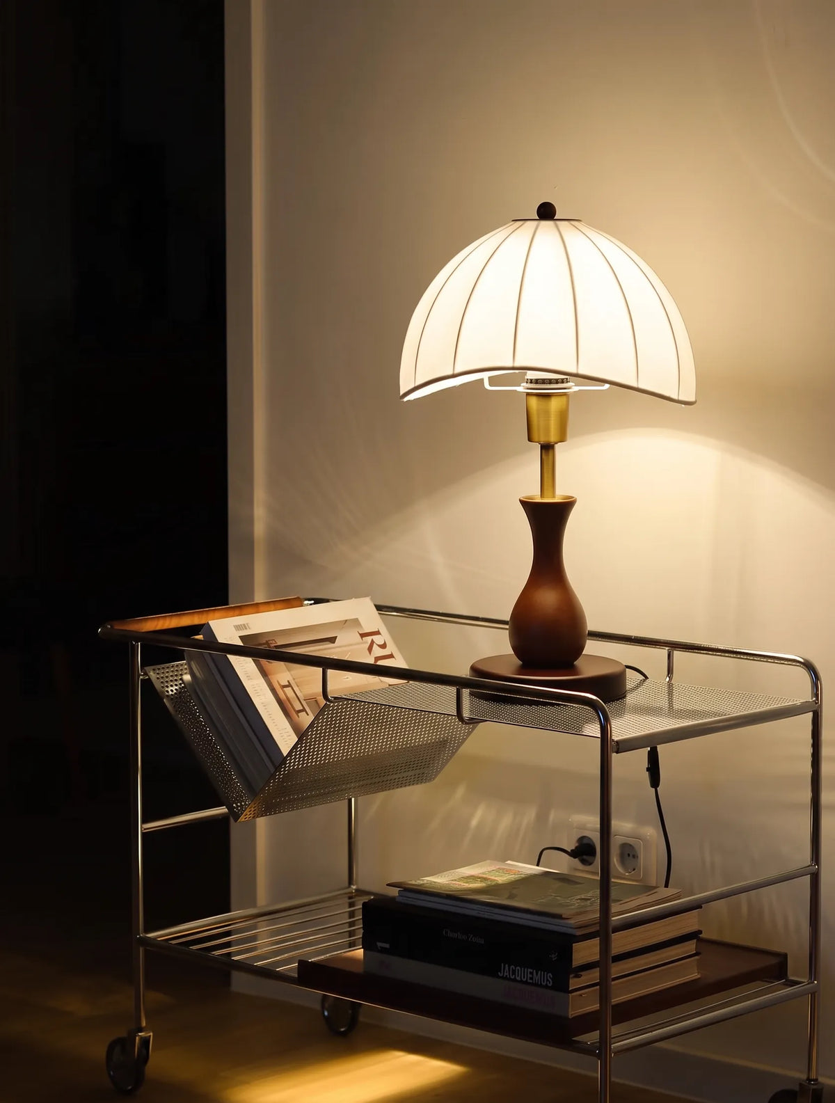 Lámpara de mesa retro de madera Viselda – encendida sobre un carrito auxiliar