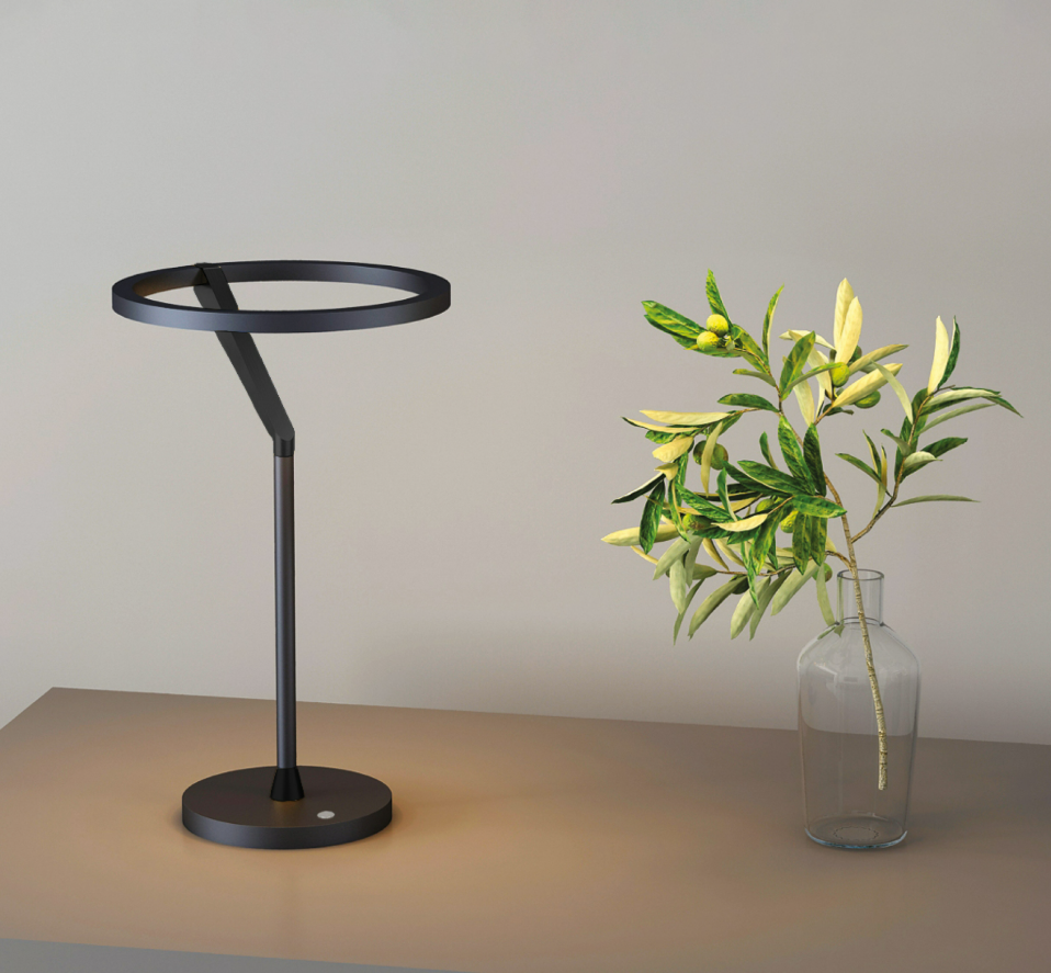 Lámpara de mesa LED con aro de luz Orlena – en negro junto a un jarrón