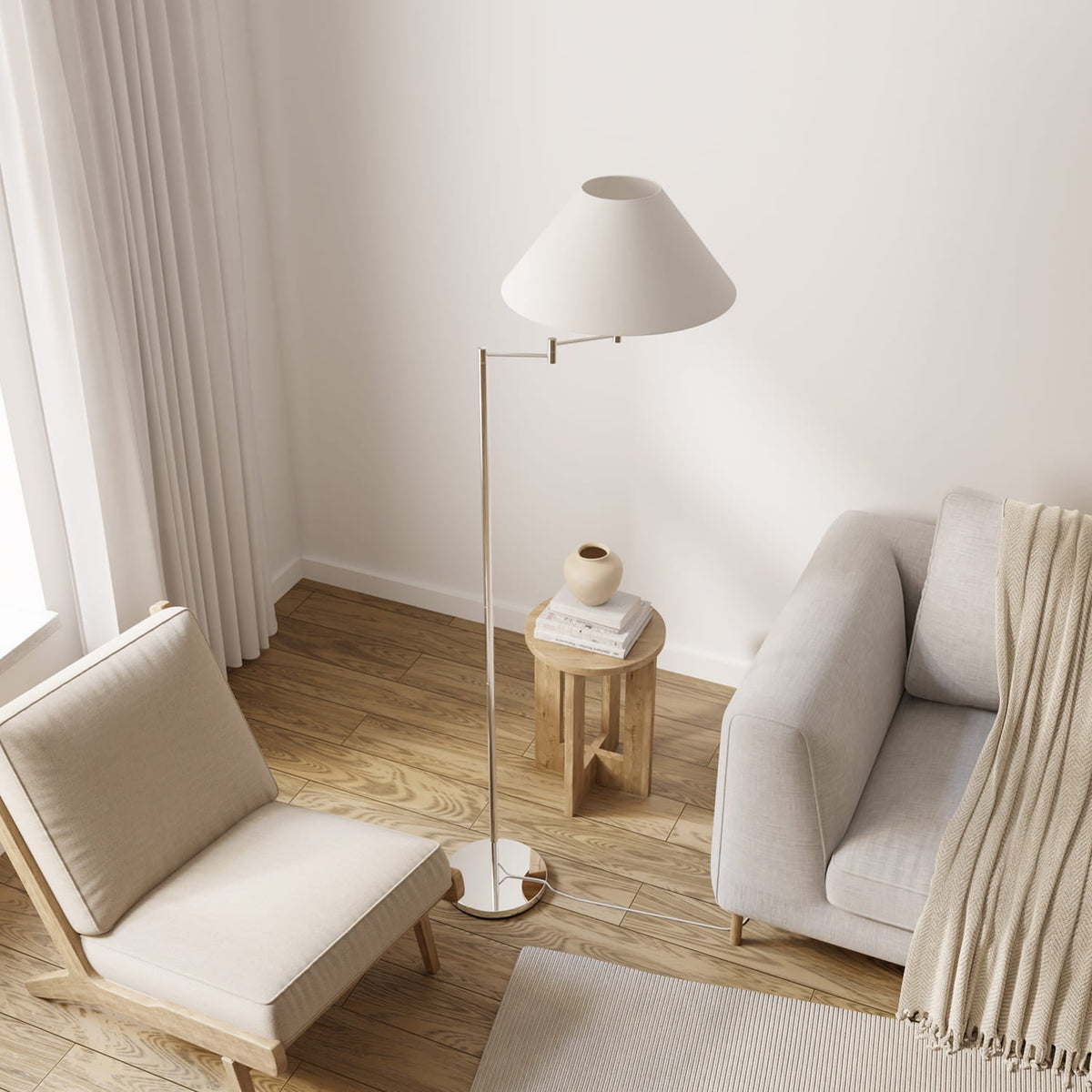 Lámpara de pie con brazo giratorio Pavena junto a un sillón – imagen 5