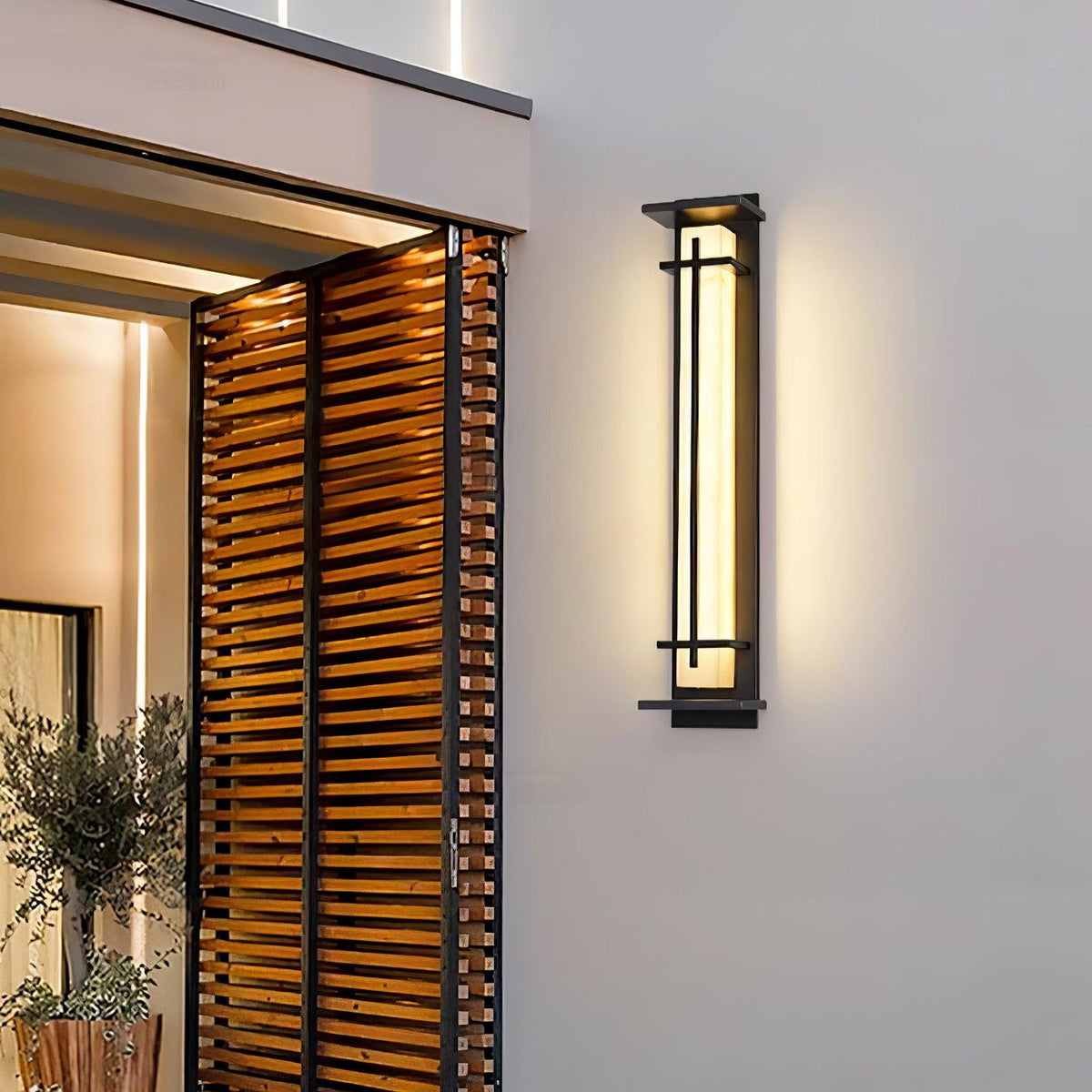 Aplique de pared exterior LED Xalba con efecto alabastro en una fachada al anochecer – imagen 15