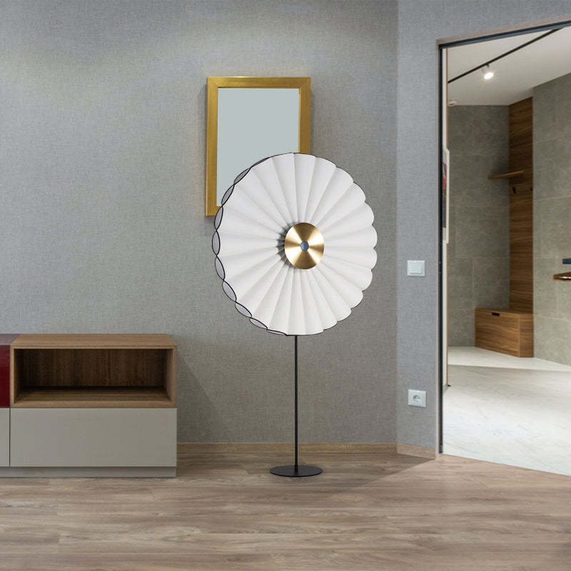 Lámpara de pie LED con disco plisado Zirena – blanca en un recibidor