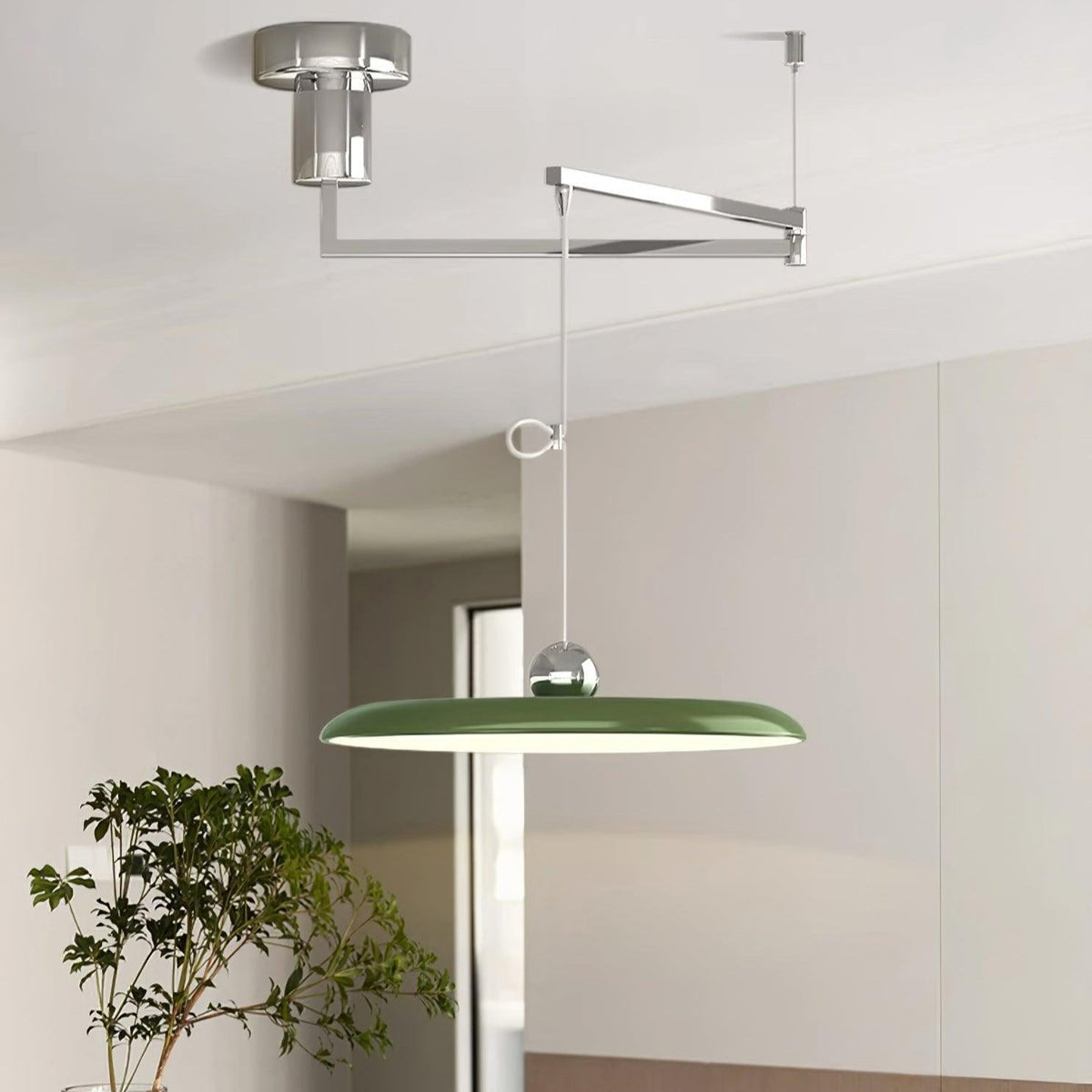 Lámpara colgante LED con brazo giratorio Balancia – en verde con brazo cromado sobre una cocina