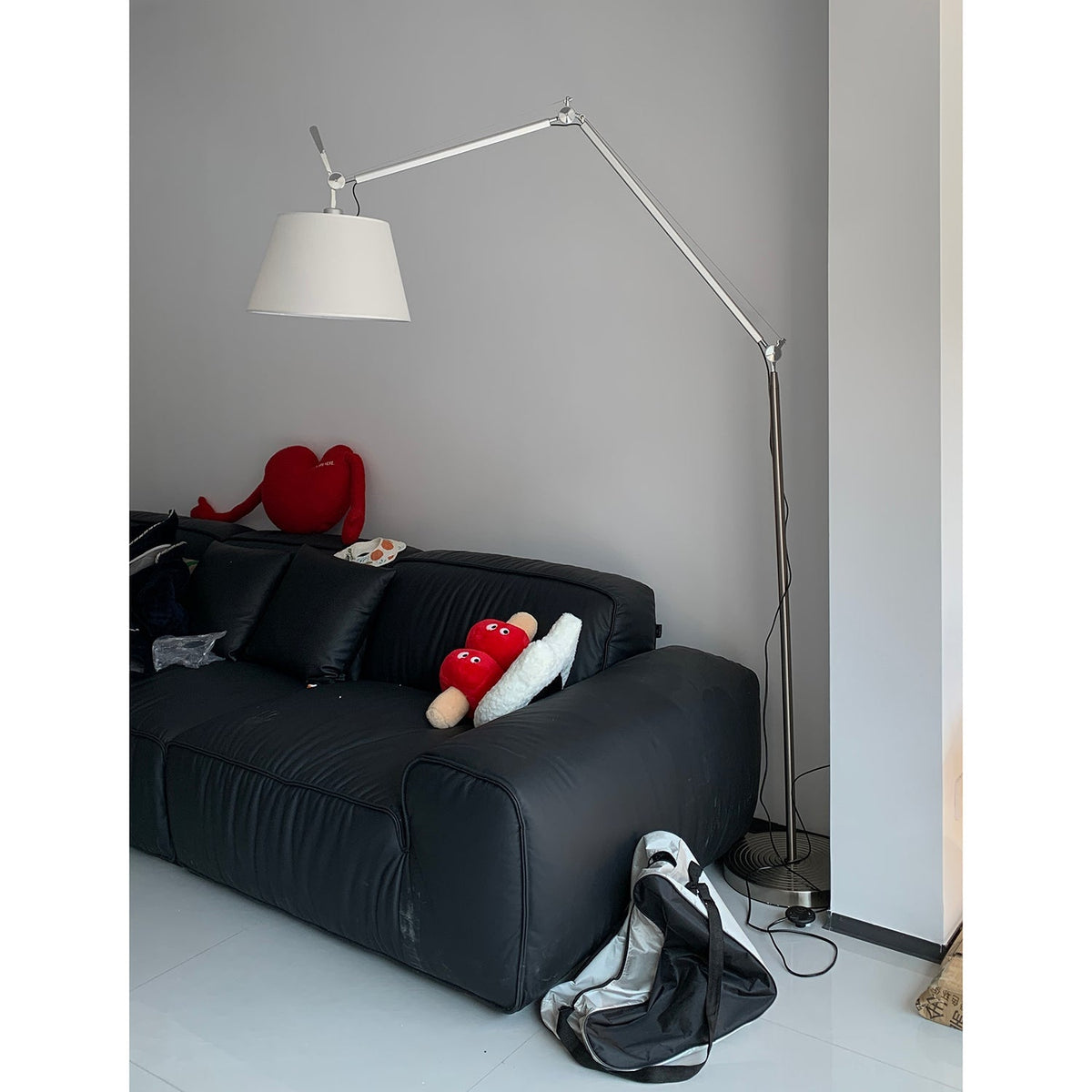 Lámpara de pie con brazo articulado Belmora junto a un sofá del salón – imagen 28
