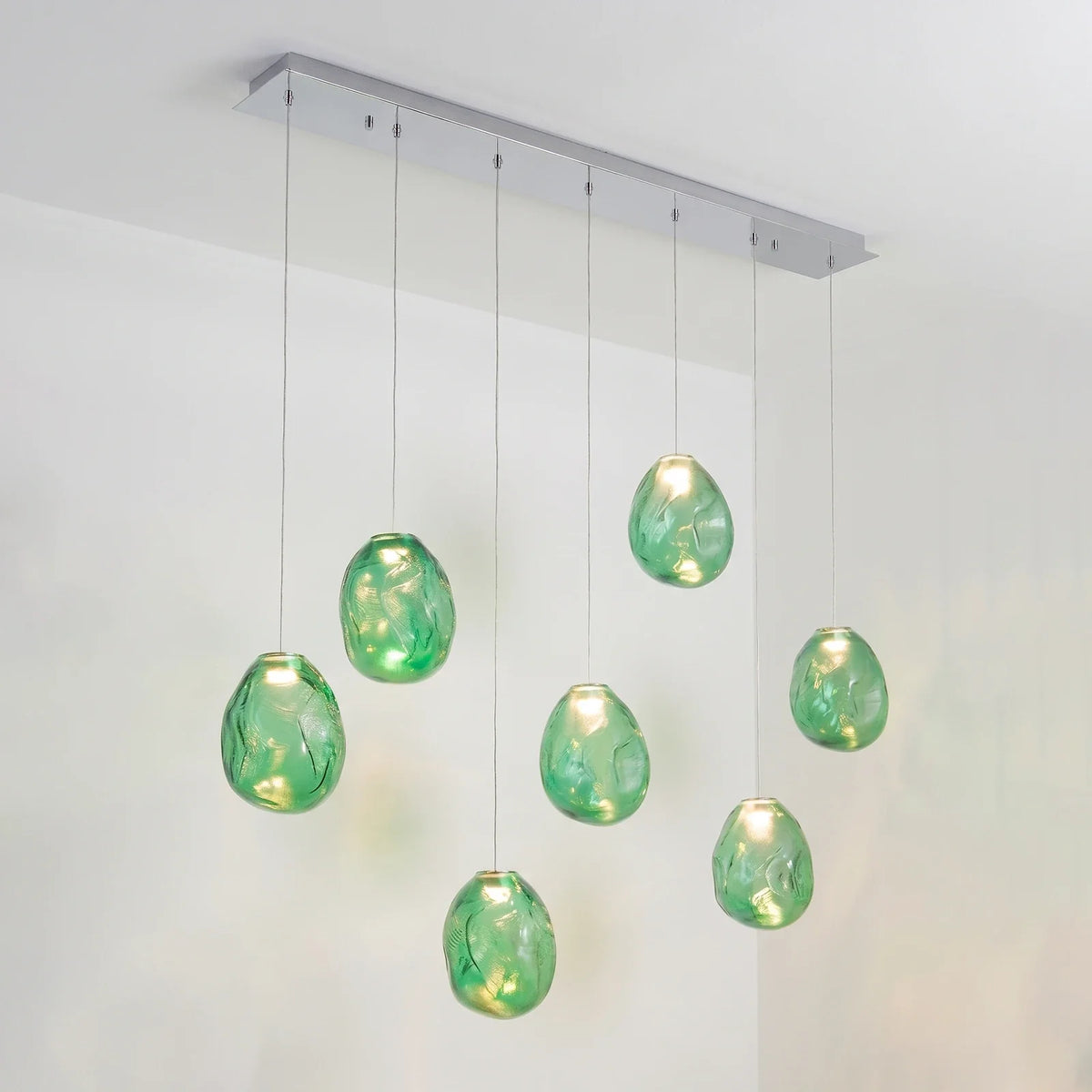 Lámpara de araña de cristal texturizado Guisela – lineal de 7 luces en cristal verde