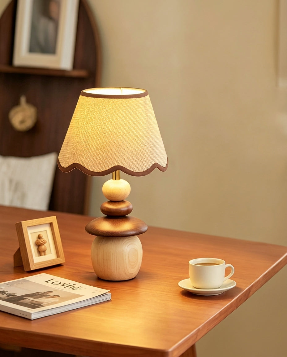 Lámpara de mesa de madera Frenela – en una mesita con marco de fotos y taza de café