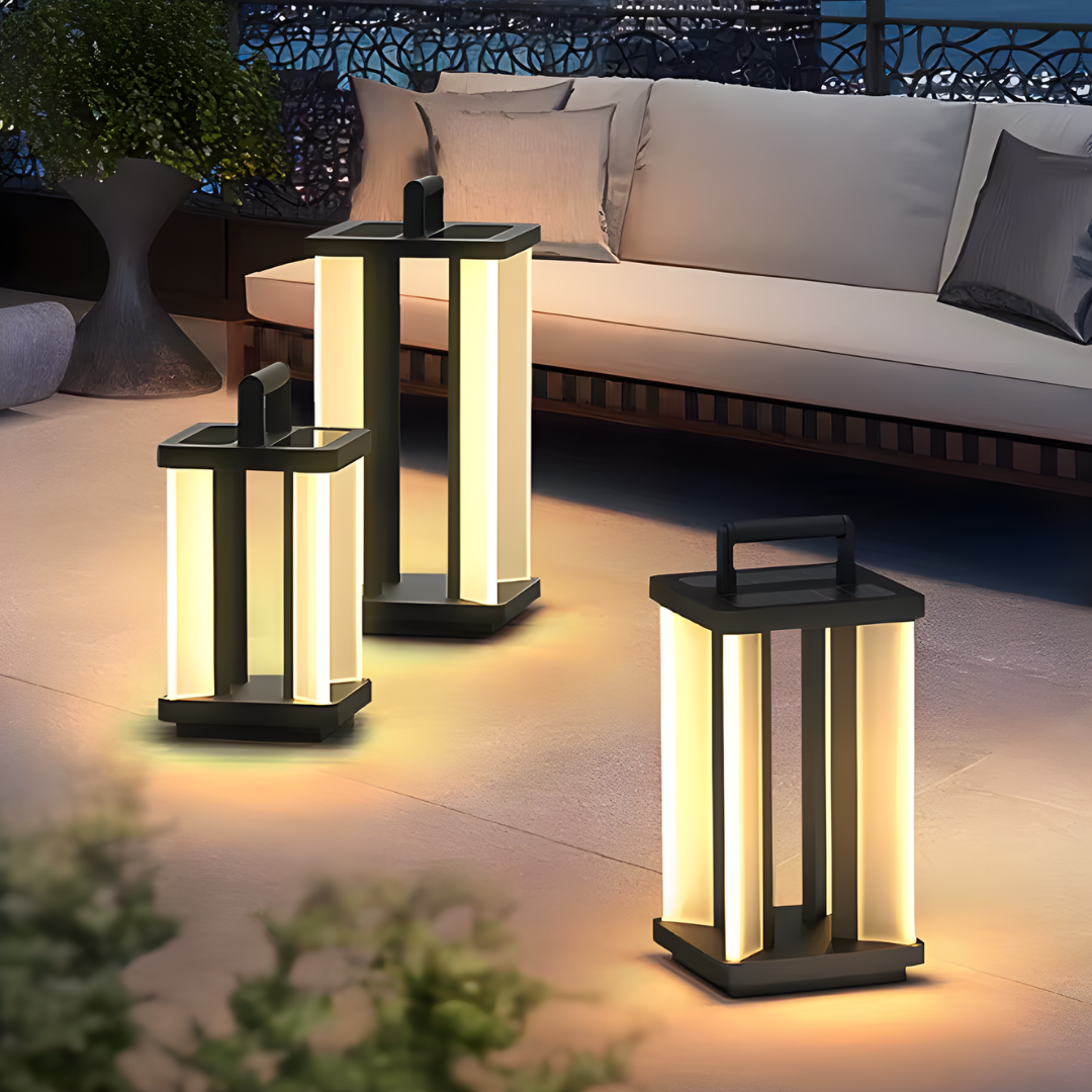 Farol de suelo exterior Jolina – junto a un sofá de exterior