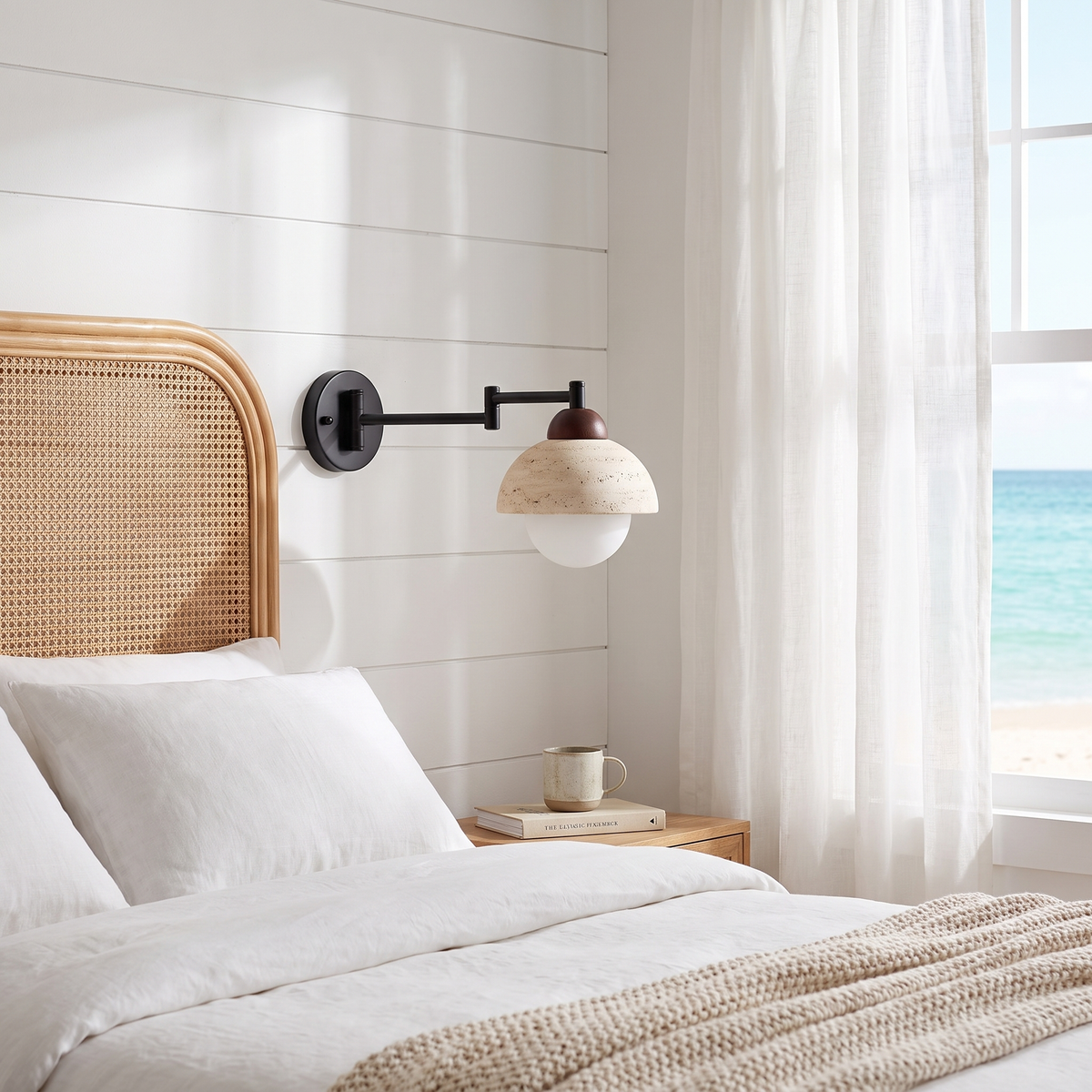 Aplique de pared Xalina con brazo articulado y pantalla de travertino – en un dormitorio costero