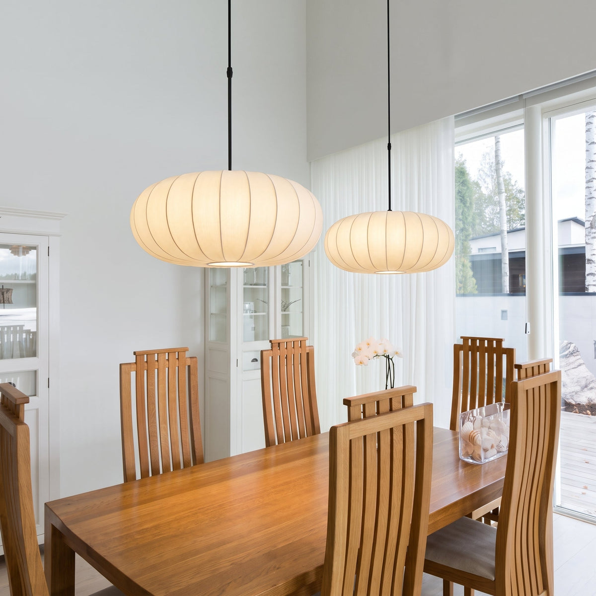 Lámpara colgante de seda Hilena sobre una mesa de comedor – imagen 2