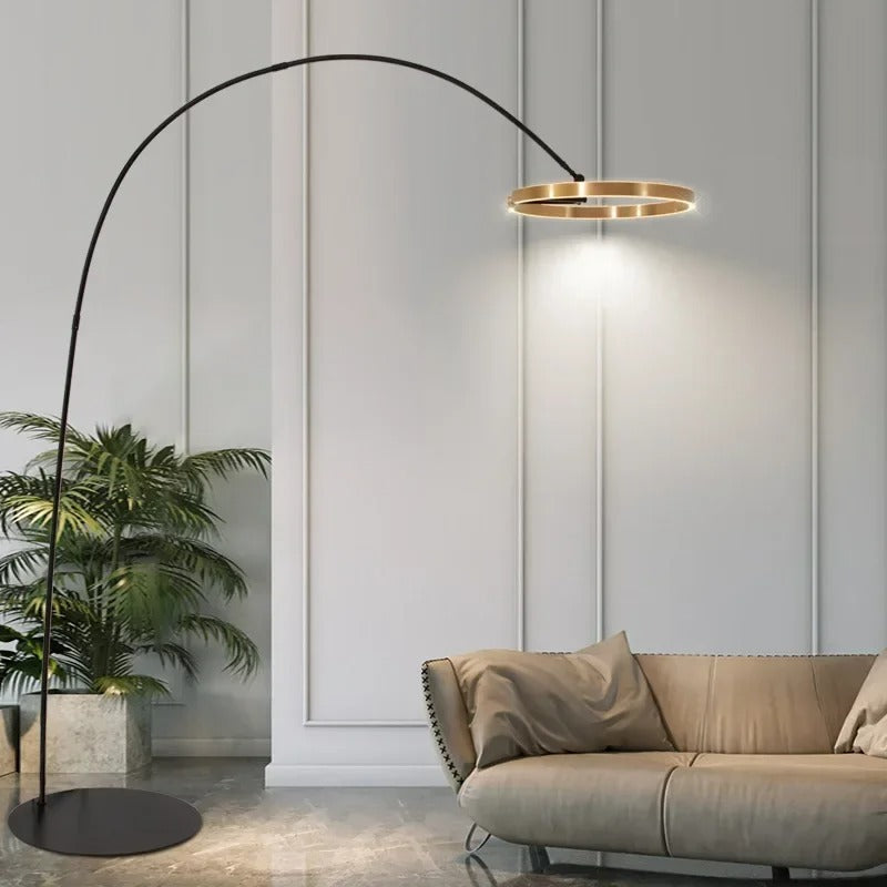 Lámpara de pie arco LED Pamira con aro de luz – junto a un sofá