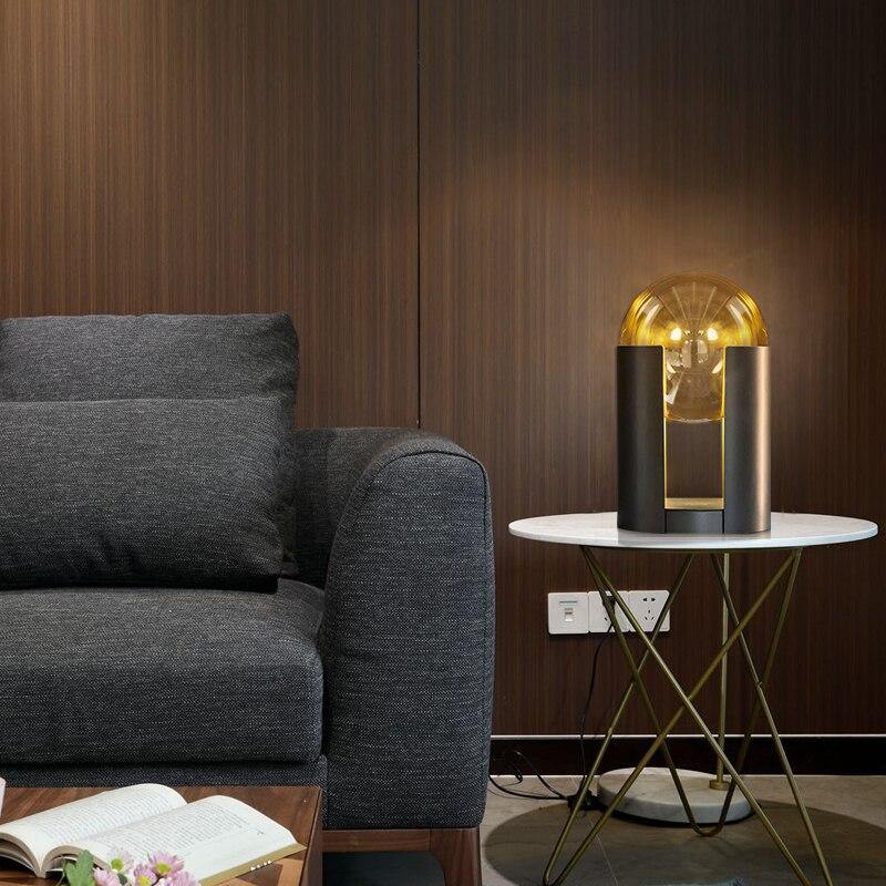 Lámpara de mesa de cristal Tolvia – junto a un sillón