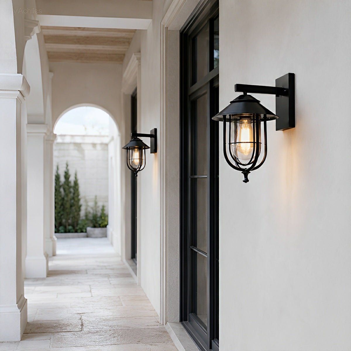 Aplique de pared exterior Jaulina – en un pasillo exterior con arcos