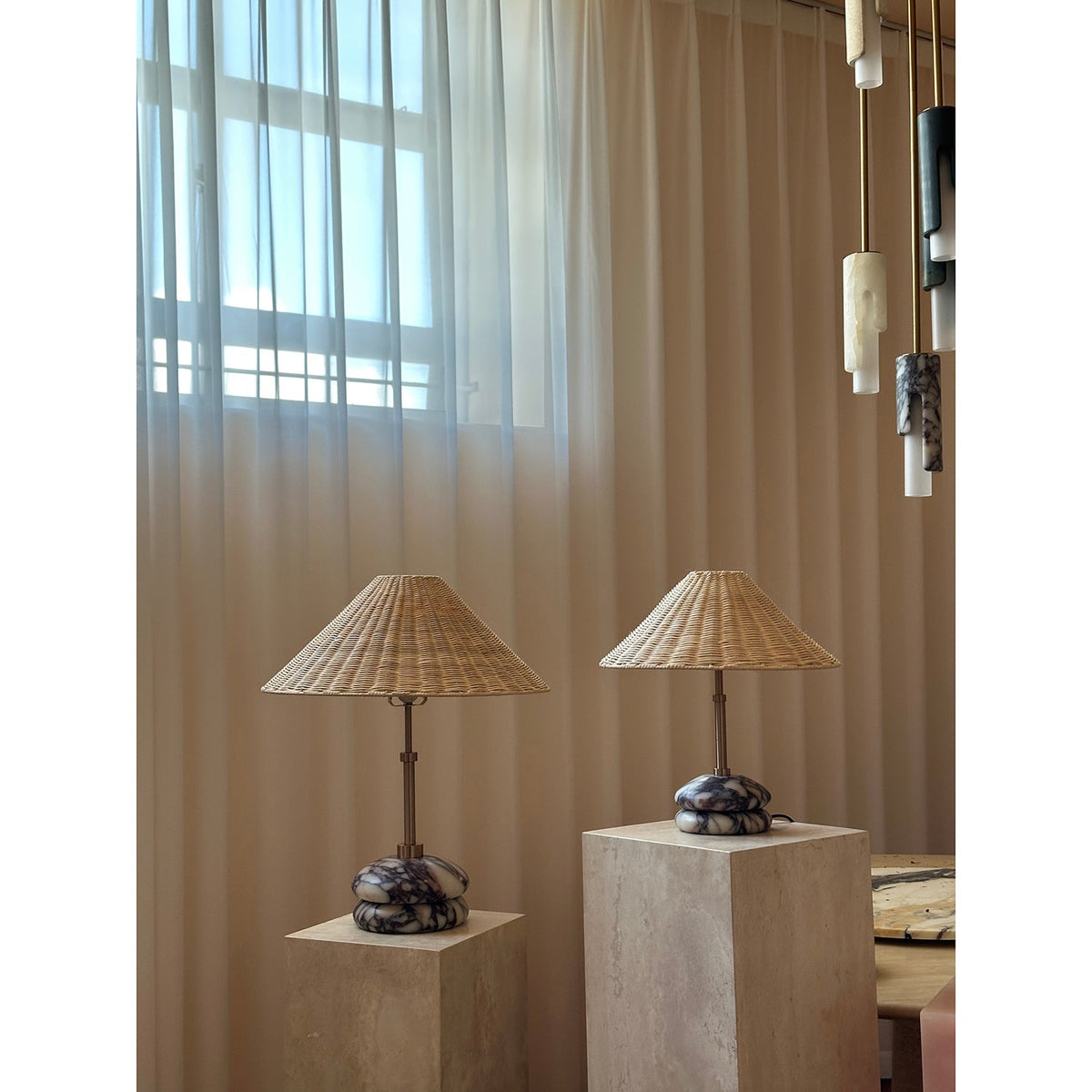 Lámpara de mesa de mármol y ratán Tejuela – pareja en un salón luminoso