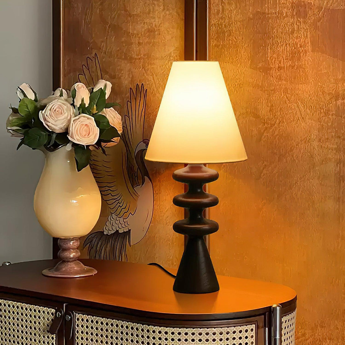 Lámpara de mesa de madera Undora – en negro sobre un aparador