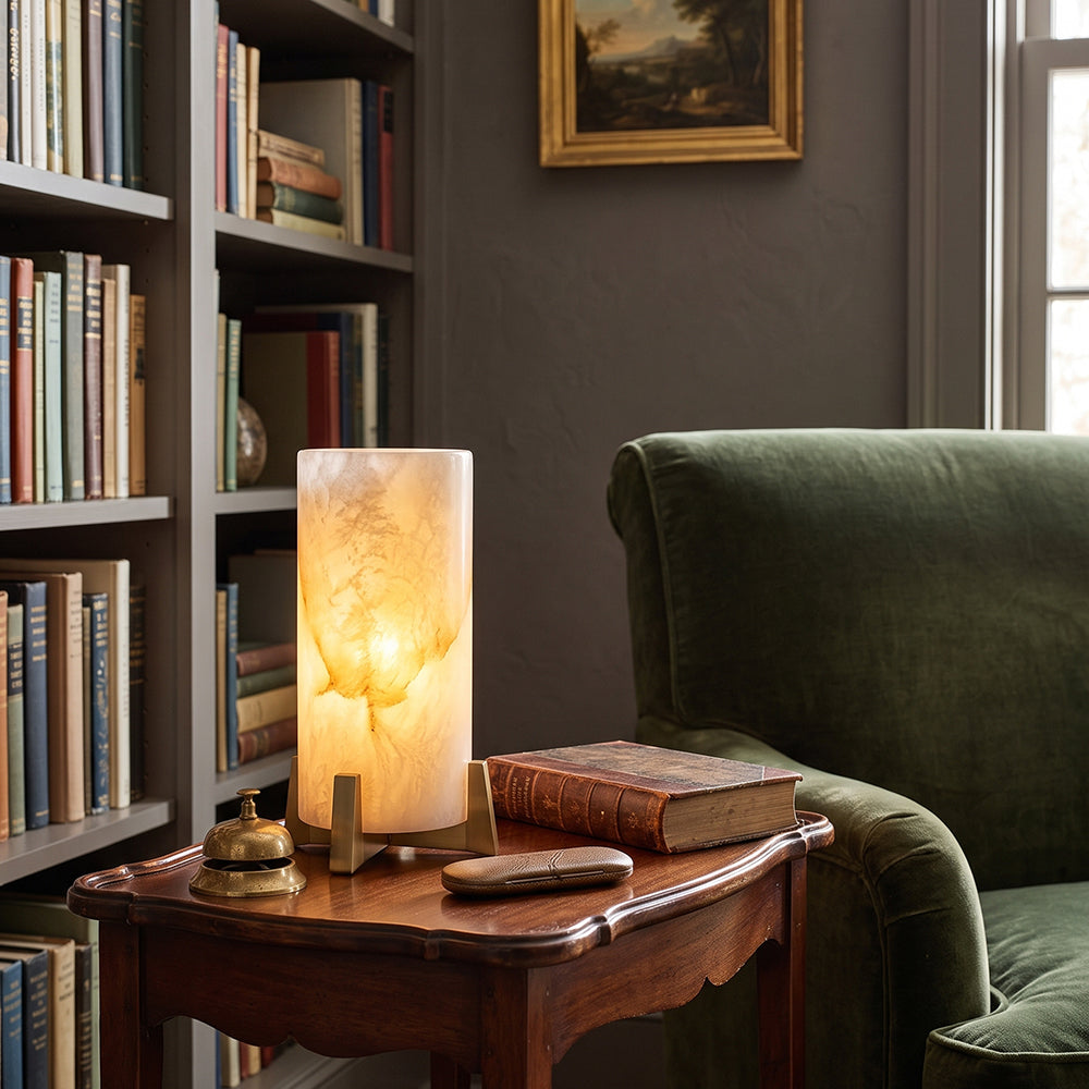 Lámpara de mesa de alabastro Velara – en un rincón de lectura con librería