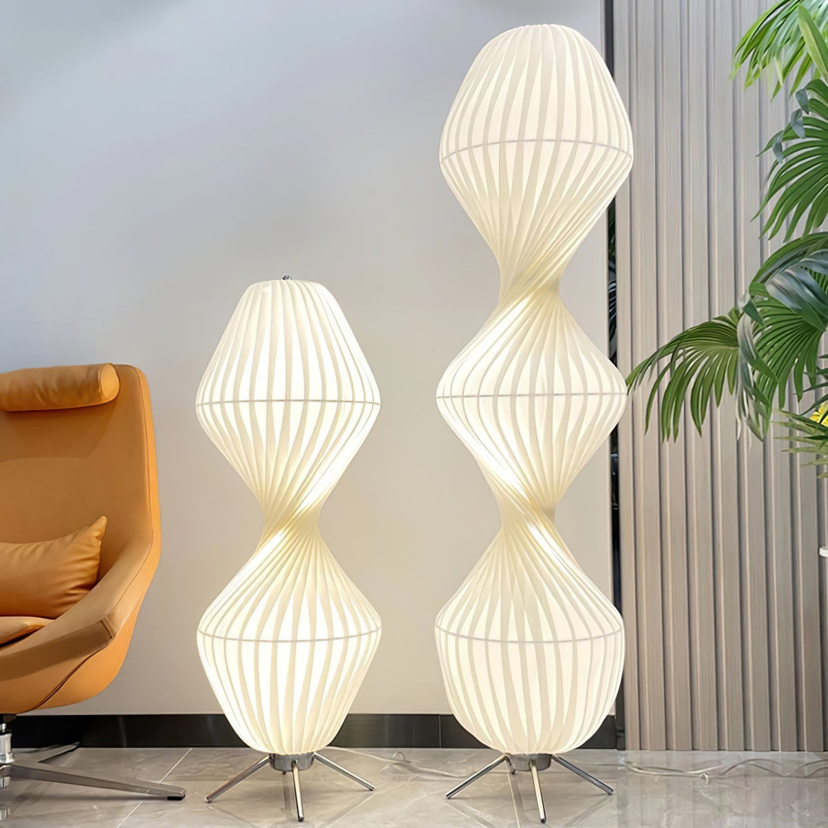 Lámpara de pie LED torsionada Vrilla – en sus dos alturas junto a una butaca